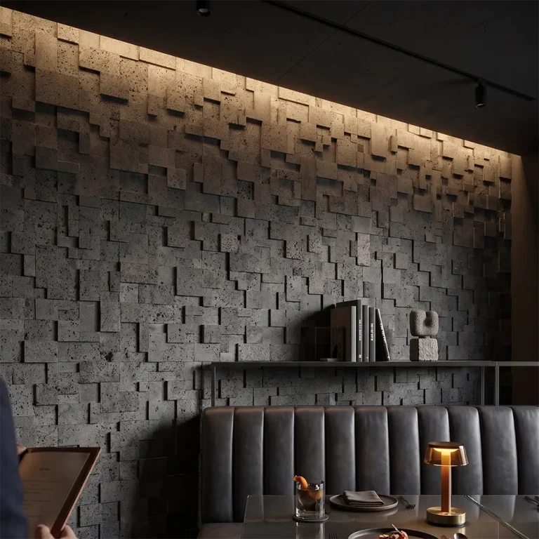 Close-up texture of dark grey 3D volcanic rock wall tiles, showing staggered lava stone blocks with natural porous holes, manufactured by Caron Stone.