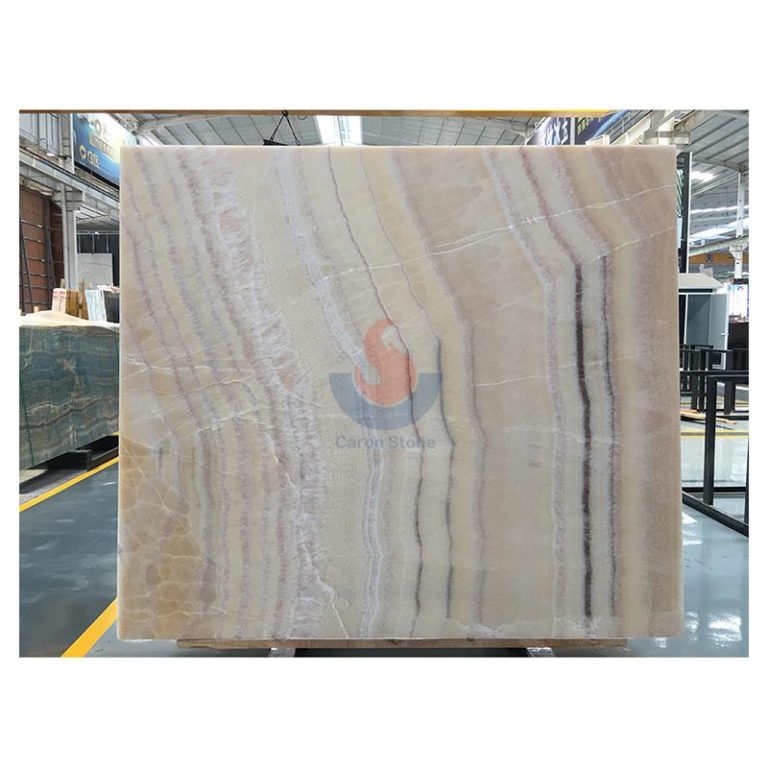 Full jumbo slab of polished Pink Peach Onyx featuring soft rose and apricot linear banding by Caron Stone.