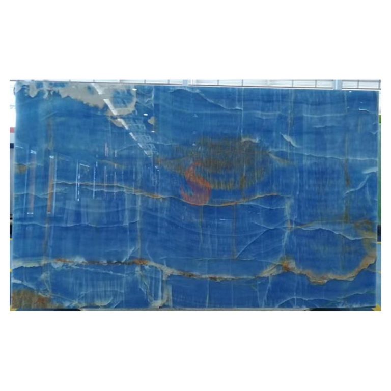 Full jumbo slab of natural Royal Blue Onyx with deep azure background and horizontal golden mineral bands, supplied by Caron Stone.
