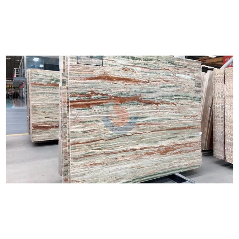Full jumbo slab of natural Green Onyx featuring vibrant emerald banding and rust-red mineral veins, supplied by Caron Stone.