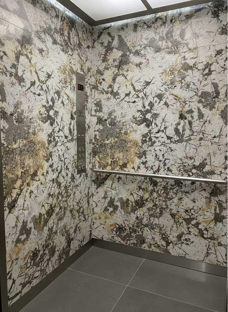 Lightweight Stone Panels for Elevators and Yachts The interior of a commercial elevator cab featuring lightweight ultra-thin Patagonia Quartzite stone panels applied to the walls.
