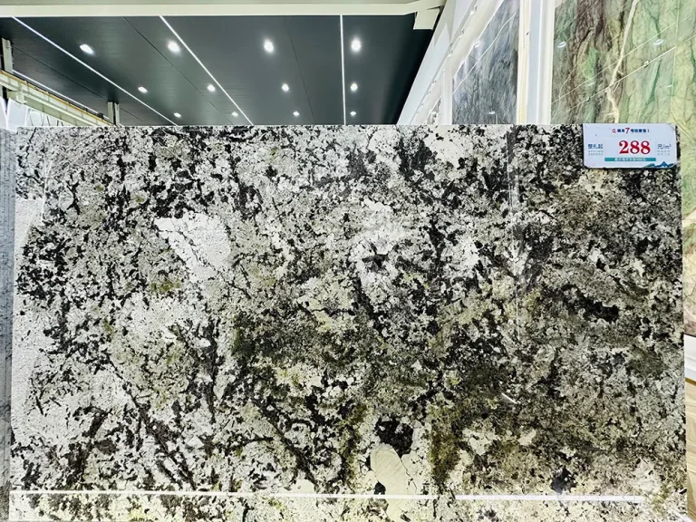 A massive, highly polished Patagonia Quartzite slab showcasing a chaotic, graphic pattern of deep black veins, bright white patches, and translucent crystal inclusions in a showroom.