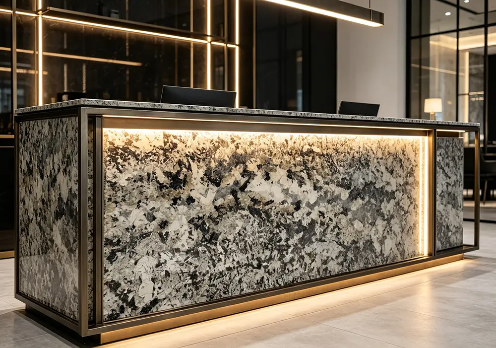 A massive, thick-edged Patagonia Quartzite waterfall island serving as the vibrant focal point in a sleek, ultra-minimalist kitchen featuring matte black cabinetry.