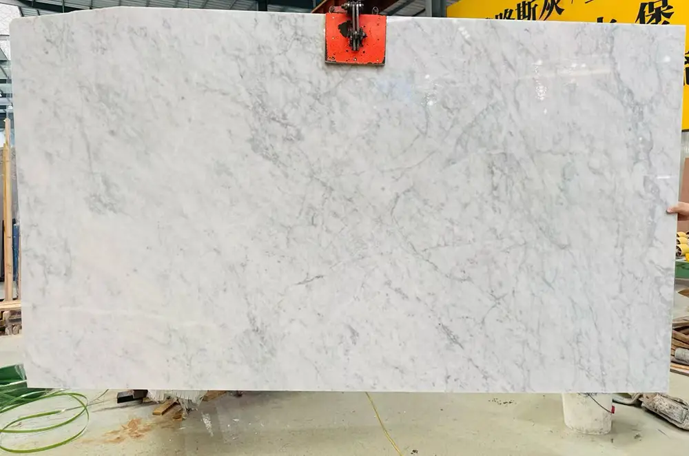 carrara-marble-slab-digital-templating-caron-stone Premium jumbo slab of natural white Italian Carrara marble inside the factory yard, ready for digital vein-matching mapping.
