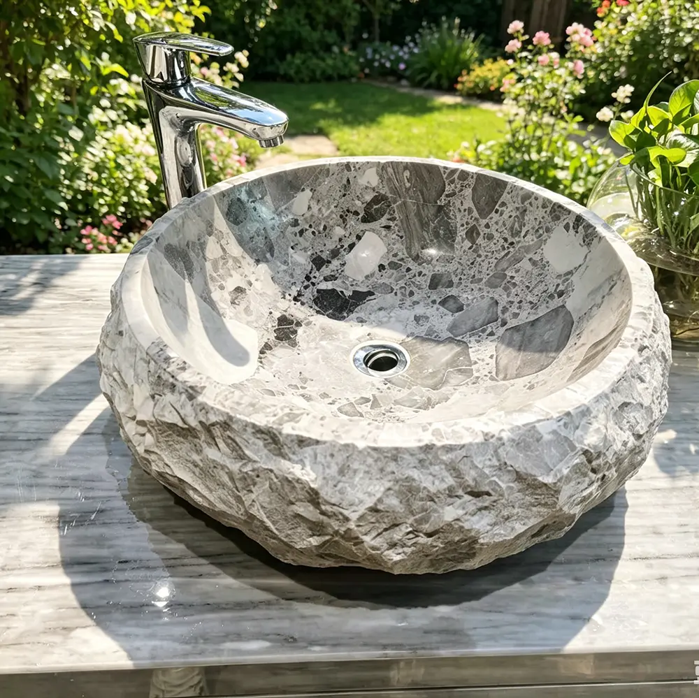Artisan Hand-Chiseled Rock Face Detail Extreme close-up showing the transition from the smooth interior lip to the rugged, hand-chiseled exterior of the Ceppo Noir marble basin.