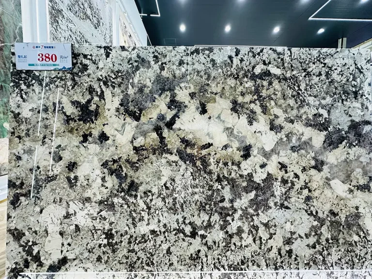 A dramatic Patagonia Crystalline Quartzite slab showcasing a high-contrast, brecciated pattern with massive blocks of clear quartz surrounded by dense, speckled black minerals.