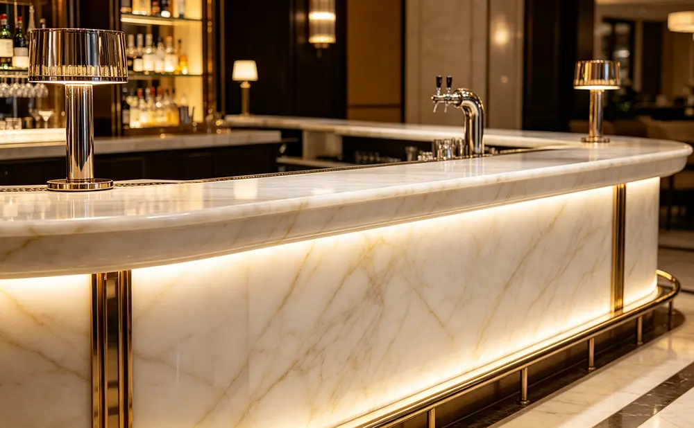Luxury commercial bar counter featuring an illuminated White Onyx front fascia and top.