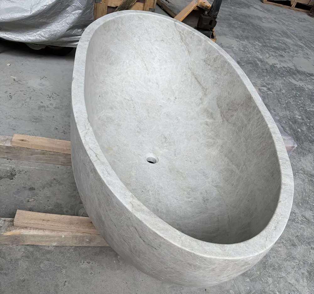 Premium Quartzite Block Selection Massive raw blocks of natural Taj Mahal Quartzite in the Caron Stone factory yard, selected specifically for carving solid bathtubs.